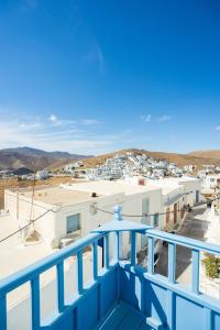 a blue balcony with a view of a city at Margarita's Houses in Astypalaia Town