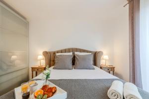 a bedroom with a bed with a tray of food on it at Le Havre du Bois Coquard - Proche Disney in Chessy