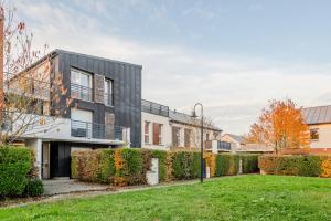 an exterior view of a building with a yard at Le Havre du Bois Coquard - Proche Disney in Chessy