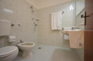 a bathroom with a toilet and a sink at Appartamenti Foyer in Bibione