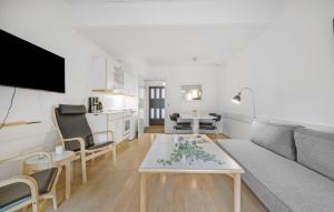 a living room with a couch and a table at 1 Bedroom Lovely Apartment In Nexø in Neksø