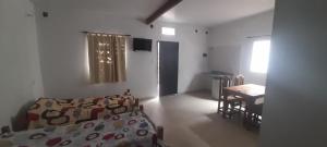 a bedroom with a bed and a table and a desk at Avenida Colon in Santiago del Estero