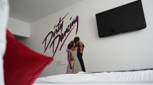 a poster of a couple on a wall in a bedroom at Amical Hotel Hagen in Hagen +59 photos