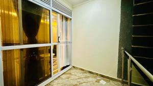 an empty room with a window and a balcony at Serenity luxury Naalya in Kampala