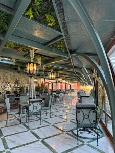 a dining room with chairs and tables and ceilings at Goldenburg Residence in Plovdiv