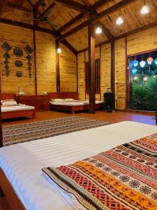 a large room with a bed and a large rug at La Vie En Rose Ba Vì Homestay in Hanoi