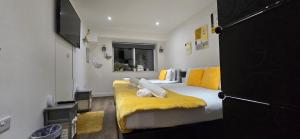 a bedroom with a bed with a yellow blanket at Ws Apartments - Luxury 1 bed in Watford Central in Watford