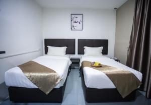 Postel nebo postele na pokoji v ubytování Rex City Hotel