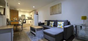 a living room with a couch and a kitchen at Ws Apartments - Luxury 1 bed in Watford Central in Watford