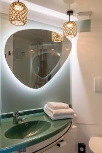 a bathroom with a green sink and a mirror at ibis Styles Pontivy centre Bretagne in Pontivy +59 photos
