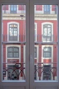 a window with a view of a building at Almada Music in Porto