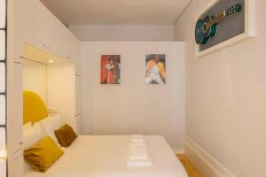 a room with a bed with two pictures on the wall at Almada Music in Porto