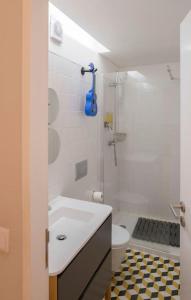 a bathroom with a shower and a sink and a toilet at Almada Music in Porto