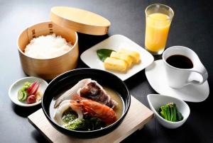 a table with a bowl of food and a plate of rice at GranVista角島 in Oyama