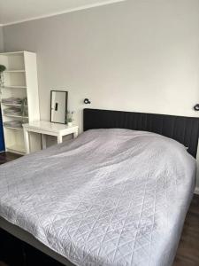 a bedroom with a large bed with a white comforter at Familienfreundliche Unterkunft in Rietberg +26 photos