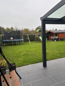 a view of a backyard with a playground with a swings at Familienfreundliche Unterkunft in Rietberg