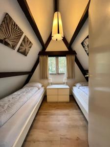 a room with two beds and a window at Chalet 146 Arrivée in Durbuy +20 photos