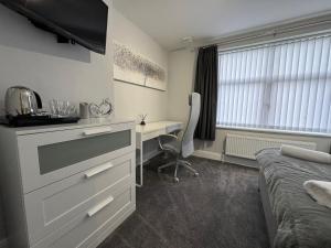 a bedroom with a desk and a bed and a desk and a desk at LYMM LIVING in Warrington