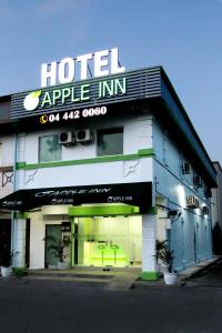 a hotel with a sign on the front of it at Apple Inn Hotel in Sungai Petani