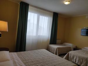 Postelja oz. postelje v sobi nastanitve Albergo Conte Max