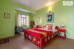 a bedroom with a large bed in a room with green walls at StayVista at Luitel Homestay with Mountain View in Gangtok