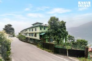 a house on the side of a road at StayVista at Luitel Homestay with Mountain View in Gangtok