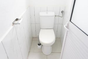 a white bathroom with a toilet in a stall at Villas Floralies in Grand-Baie +9 photos