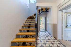 a staircase in a house with a checkered floor at Maison Fontanieres studio Le Roule in La Mulatière