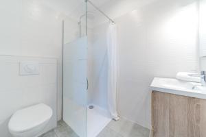 a bathroom with a shower and a toilet and a sink at Maison Fontanieres studio Le Roule in La Mulatière