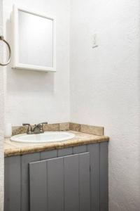 a bathroom with a sink and a mirror at Bo360 Bungalow with Hot Tub and Sauna in Billings +12 photos
