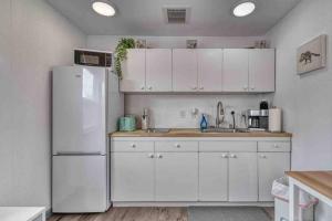 a kitchen with white cabinets and a white refrigerator at Bo360 Tiny House Unique Country Retreat with Hot Tub in Puyallup +14 photos