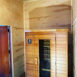 a small room with a wooden wall and a door at Bo360 Bungalow with Hot Tub and Sauna in Billings