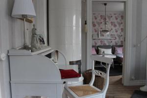 a room with a white table and chairs and a room with a couch at Villa Lilla Pärla in Virserum
