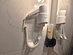 two hair dryers are attached to a wall at Gpxclr MicroLuxeSuite in Larisa