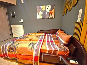 a bedroom with a bed with a blanket on it at Gpxclr MicroLuxeSuite in Larisa
