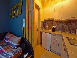 a kitchen with a chair in the corner of a room at Gpxclr MicroLuxeSuite in Larisa