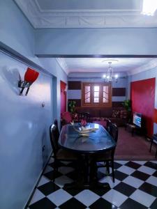 a dining room with a table and a living room at Fayrouzat Smoha city with open view in Alexandria