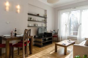 a living room with a dining table and a television at VIP Apartments Sofia in Sofia