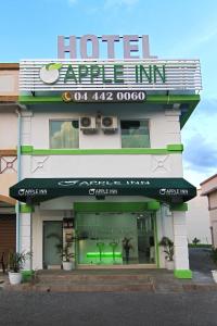 a hotel entrance with a sign on top of it at Apple Inn Hotel in Sungai Petani