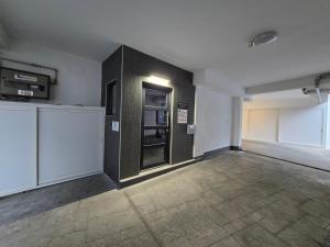 an empty room with a black refrigerator in it at Gpxclr MicroLuxeSuite in Larisa