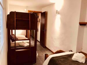 a room with a bunk bed and a room with a bed and a mirror at Spaziosa taverna accanto alle piste da sci in Courmayeur