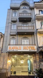 a hotel with a sign in front of a building at Hawaii Hotel Dalat in Da Lat