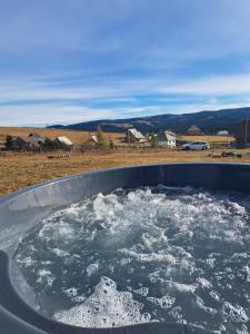 a bath tub filled with snow in a field at Tiny House Maguri in Măguri