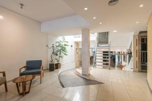 a living room with a staircase and a table and chairs at Dorrego Premium in Rosario