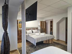 una camera da letto con un letto grande in una stanza di CĂSUȚA DIN ȘIPOT pe Cricovul Dulce a Sultanu