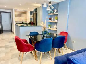 a dining room with a table and red chairs at The Sapphire Suite - 2 BR Near Beach & TGV Station in Tangier