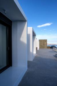 a view from the hallway of a white building at Magic Cave Villa in Tinos in Agios Sostis