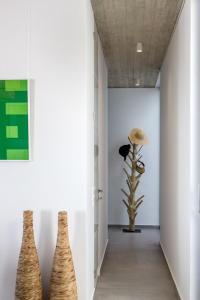 a hallway with two vases on the wall at Magic Cave Villa in Tinos in Agios Sostis