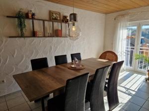 a dining room with a wooden table and chairs at NEU! Ferienwohnung Beim Hubert in Waldbröl