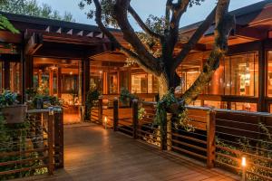 an exterior view of a house with a tree at Mariva Dune Suites in San Vincenzo